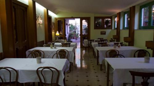 a dining room with tables and chairs with white table cloth at Hotel Benedetto in Rome