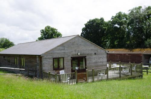 an old wooden house in a field of grass at Accessible Barn 4 Bedrooms Farm stay sleeps 8 in Mayfield
