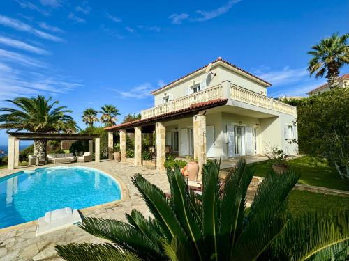 a villa with a swimming pool and a house at Villa Kephalos in Spartia