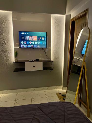 a living room with a tv on a wall at Beachfront Studios by Virani in Karachi