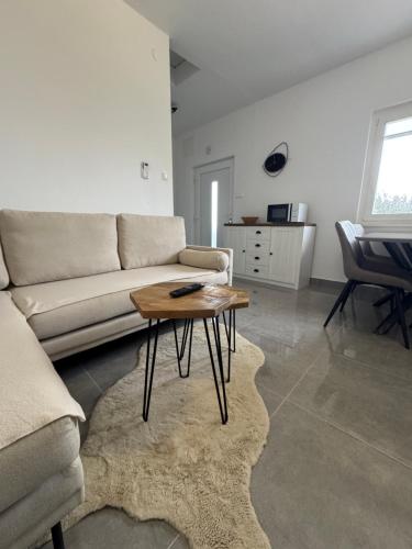 a living room with a couch and a coffee table at ANKA - apartment by the sea in Kali