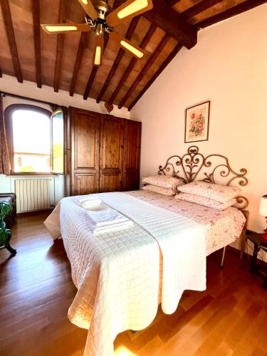 a bedroom with a large bed with a wooden ceiling at Villa Chiusagrande in Campiglia Marittima