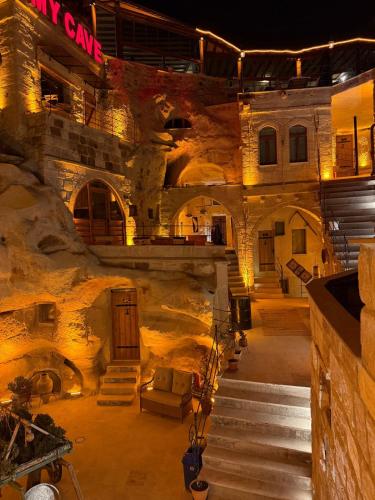 a large stone building with stairs in a room at My Cave Suites in Nevsehir