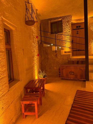 a room with two wooden benches in a building at My Cave Suites in Nevsehir