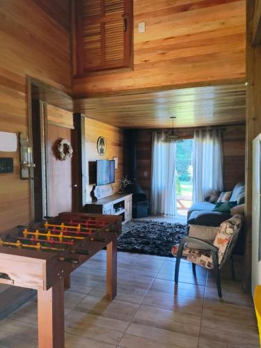 a living room with a ping pong table in it at Sitio Vida in Aguas Mornas