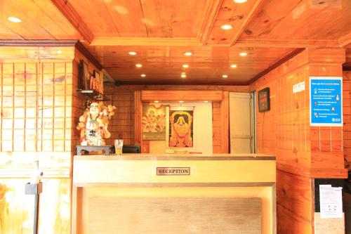 a front door of a store with a sign above it at HOTEL SHIV SHANTHI INN MOORTHI HOSPITALITY OOTy in Ooty