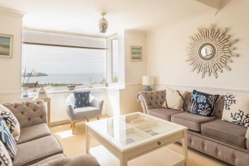 a living room with a couch and a table at 7 Bedroom House in Woolacombe - Sleeps 12 in Woolacombe