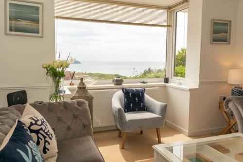 a living room with a large window with a view of the ocean at 7 Bedroom House in Woolacombe - Sleeps 12 in Woolacombe