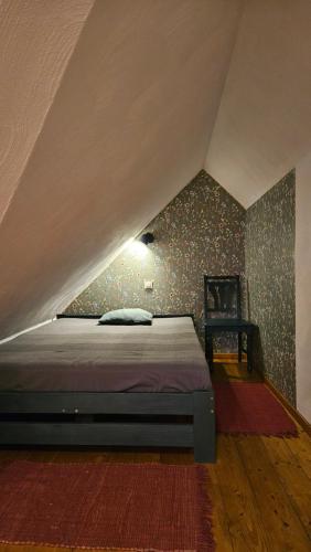 a bedroom with a bed in a attic at Miodówka in Stronie Śląskie