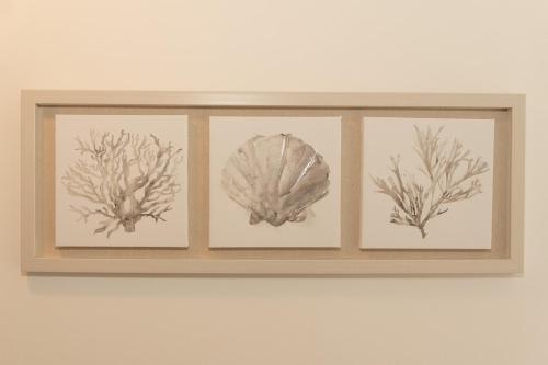 three framed prints of coral on a wall at 7 Bedroom House in Woolacombe - Sleeps 12 in Woolacombe