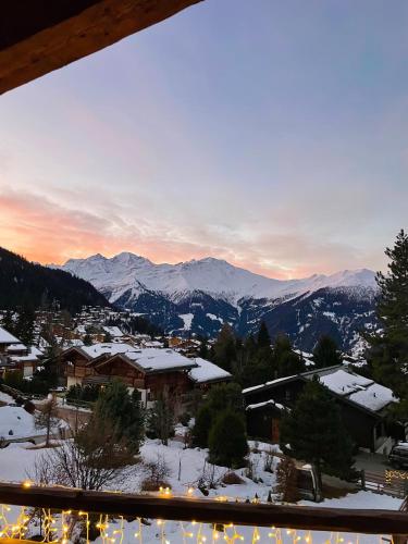 a view of a town with snow covered mountains at Chalet Les Moulins 5 chambres cheminée piscine sauna parking privé in Verbier