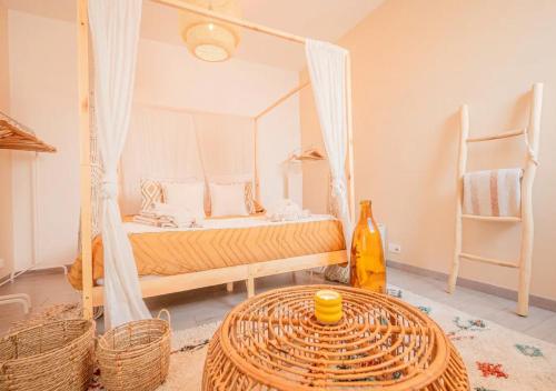 a bedroom with a bed and a table in a room at Calya Family Home in Brussels - 4 Bedrooms in Sint-Pieters-Leeuw