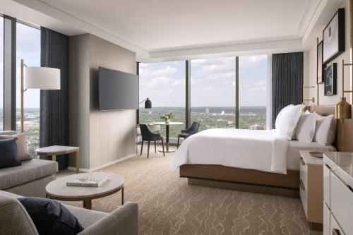 a hotel room with a bed and a large window at Four Seasons Hotel Minneapolis in Minneapolis