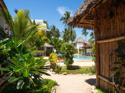 a view of a resort with a swimming pool at Pingwe Beach Apartments in Pingwe