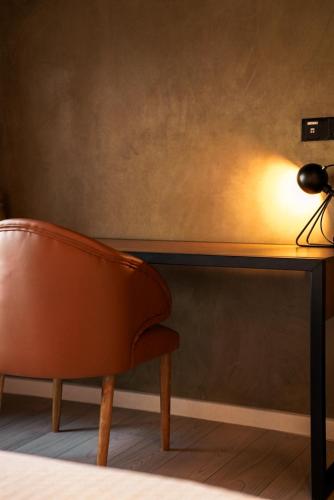 a chair in front of a desk with a lamp at VAUX Park Street Hotel - A collection of 8 luxury lofts in Colombo