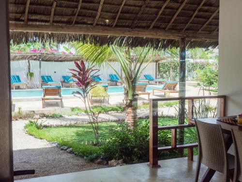 a view of the pool from the dining room of a resort at Pingwe Beach Apartments in Pingwe