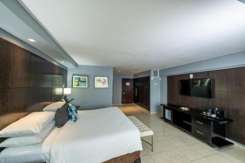 a bedroom with a large bed and a television at Hotel El Panama by Faranda Grand, a member of Radisson Individuals in Panama City