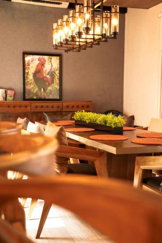 a dining room with a table and a chandelier at VAUX Park Street Hotel - A collection of 8 luxury lofts in Colombo