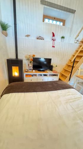 a bedroom with a large bed and a staircase at Casa de Alcaria in Alcaria