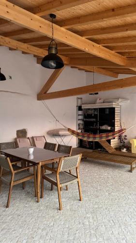a dining room with a table and chairs and a fireplace at Casa de Alcaria in Alcaria