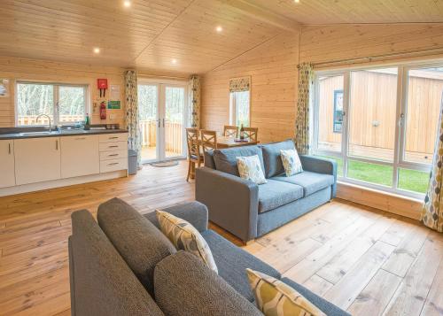 a living room with a couch and a table at Dovestone Luxury Lodges sleeps 6 - pet free in Oldham