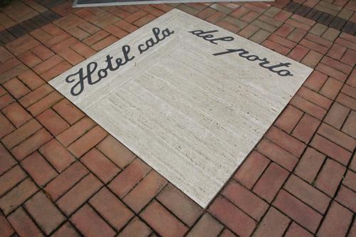 a sign on a brick floor with the words trustivedivedivedivedivedived at Hotel Cala Del Porto in Vibo Valentia Marina