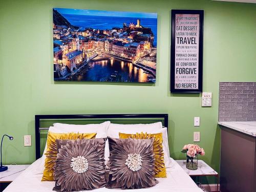 a bedroom with a bed with a painting on the wall at New! Suite near Rittenhouse Square in Philadelphia