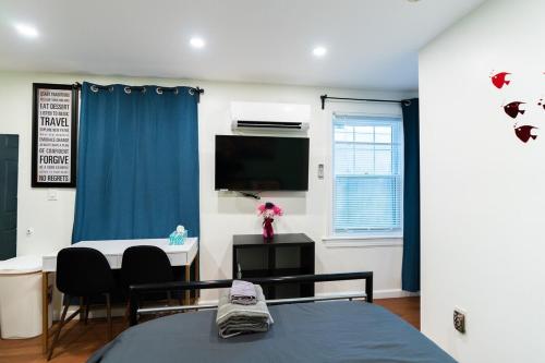 a room with a bed and a desk and a tv at New! Suite near Rittenhouse Square in Philadelphia