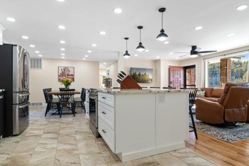 a kitchen and living room with a kitchen island and a table at Custer Gem in Custer