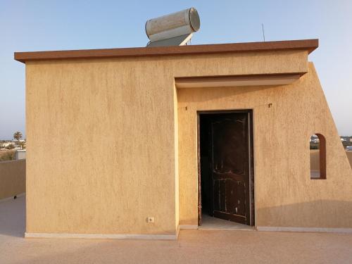 a small building with a door and a camera at Dar Jamila in Awlād ‘Umar