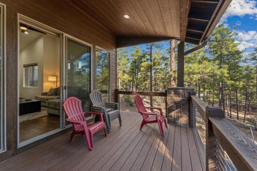 a screened in porch with two chairs and a fireplace at Scenic Golf Retreat with Modern Comforts & Fireplace townhouse in Show Low