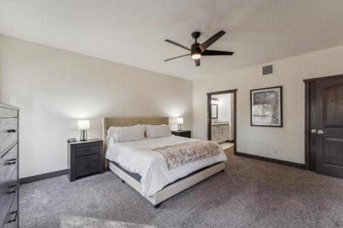 a bedroom with a bed and a ceiling fan at Scenic Golf Retreat with Modern Comforts & Fireplace townhouse in Show Low