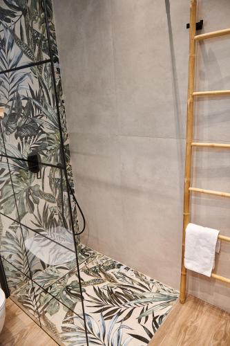 a bathroom with a shower with a wall at The Grandma's house in Artemida