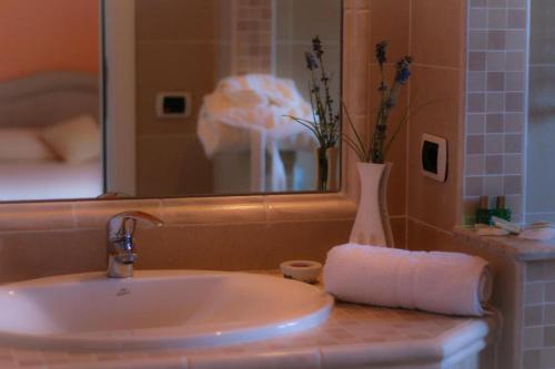 a bathroom sink with a roll of toilet paper on it at Resort Santangelo & SPA in Pimonte