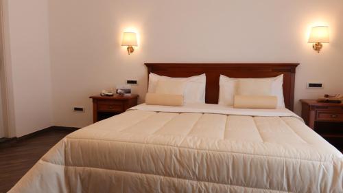 a bedroom with a large bed with two night stands at Resort Santangelo & SPA in Pimonte
