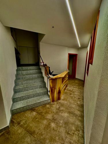 an empty hallway with stairs in a building at B&B Soreghina in Malè