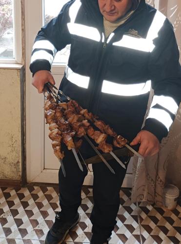 a man holding a skewer of food on a stick at GoGni OLD ROOM in Gogni