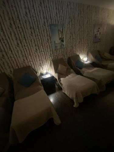 three beds in a room with lights on them at Macdonald Elmers Court Hotel in Lymington