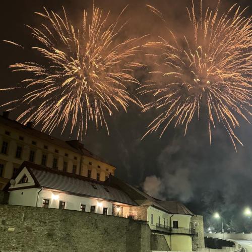 a group of fireworks exploding in the sky over a building at Dom na hradbách in Levoča