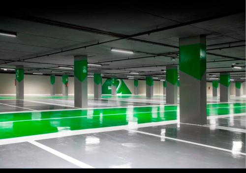 an empty swimming pool with green illumination in a building at My Bed Vatican Museum in Rome