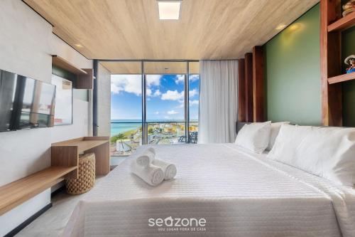 Giường trong phòng chung tại NWTs - Estúdios com Vista Lateral Mar em Maceió II