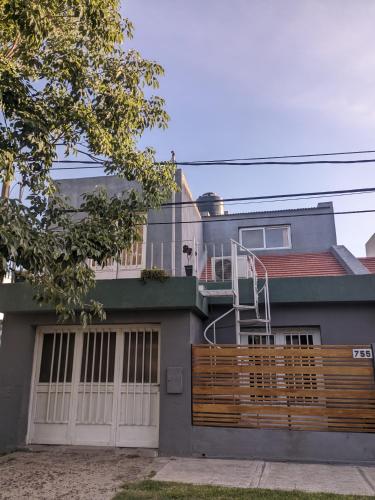 a house with a wooden fence in front of it at Apartamento Paracao in Paraná