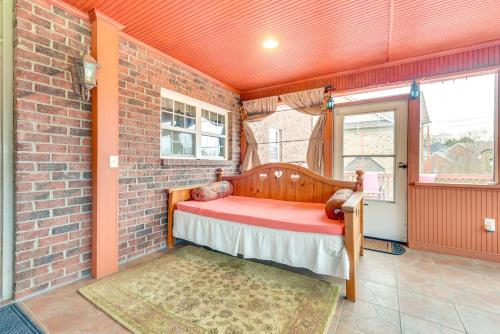 a small room with a bed in a brick wall at 3 Mi to Carowinds Retreat with On-Site Fishing in Fort Mill
