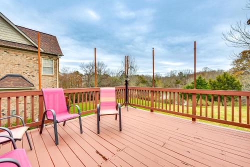 a deck with two pink chairs and a fence at 3 Mi to Carowinds Retreat with On-Site Fishing in Fort Mill
