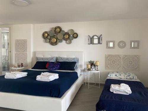 a bedroom with two beds with towels on them at A Casa di Maria in Palagiano