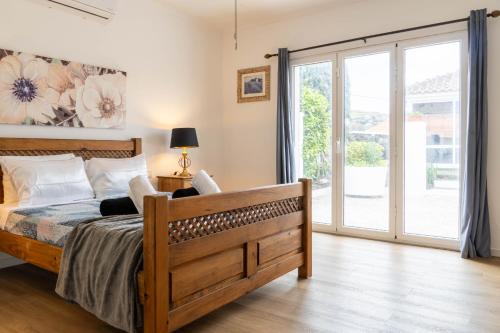 a bedroom with a bed and a sliding glass door at Mosteiros Coastal Haven in Mosteiros