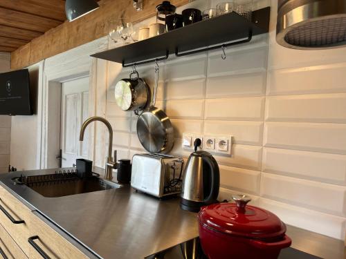 a kitchen with a sink and a counter top at Chata Vlčanda 346 in Staré Křečany