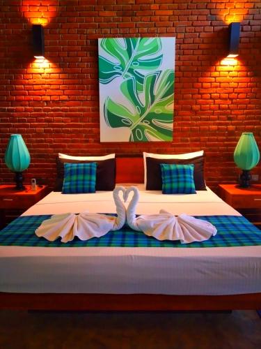 a bedroom with a bed with two pink bows at Eliyanth Udawalawe in Udawalawe