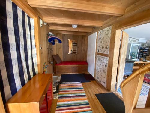 a small room with a red couch in a tiny house at Casa Vegana 4,5 Zimmer 8Pl, 3 Badezimmer in Trun