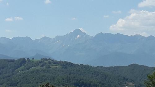 a view of a mountain range with trees and mountains at Yourte Rosane in Biert